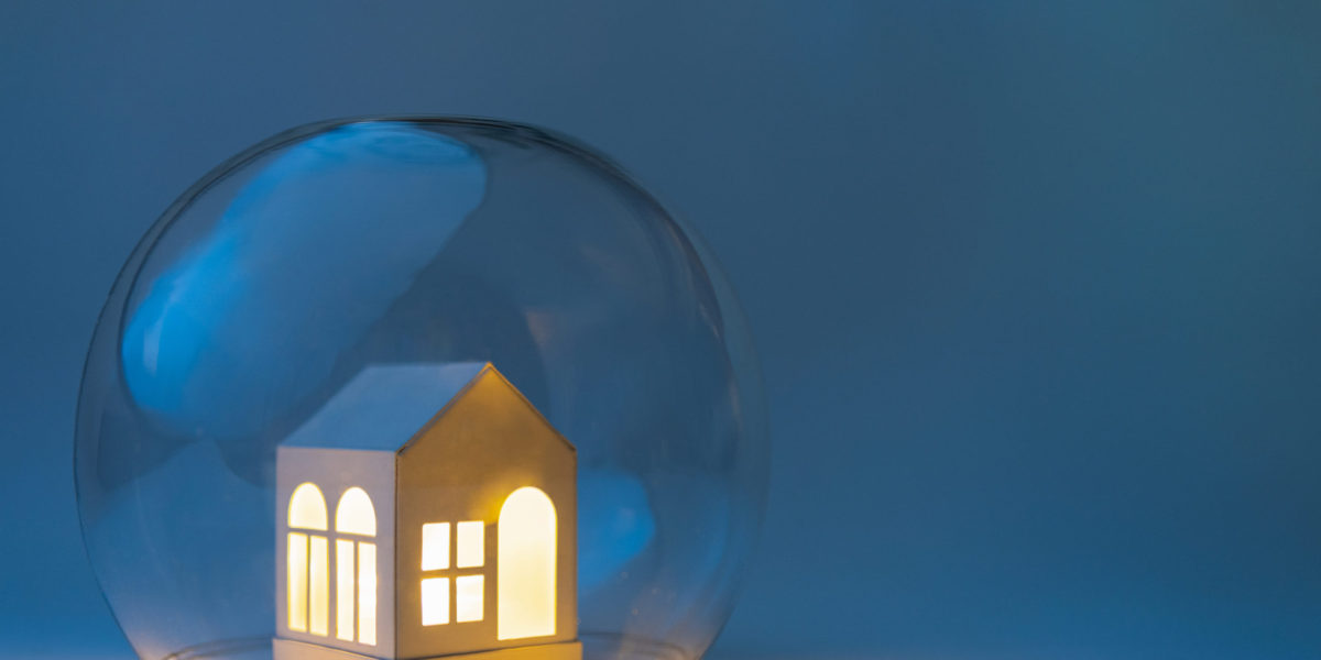 A toy house protected under a glass dome